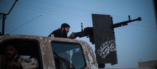 A member of Ahrar al-Sham fires against a position of the Committees for the Protection of the Kurdish People (YPG) during clashes in the countryside of the northern Syrian Raqqa province on August 25, 2013. A member of Ahrar al-Sham fires against a position of the Committees for the Protection of the Kurdish People (YPG) during clashes in the countryside of the northern Syrian Raqqa province on August 25, 2013. - Sputnik International
