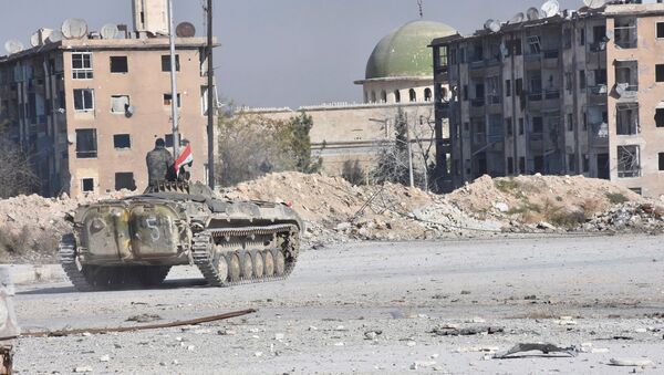 A Syrian government soldier rides a military vehicle near a mosque, after taking control of Aleppo's Al-Haidariya neighbourhood, Syria. (File) - Sputnik International