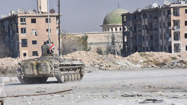A Syrian government soldier rides a military vehicle near a mosque, after taking control of Aleppo's Al-Haidariya neighbourhood, Syria in this handout picture provided by SANA on November 28, 2016. - Sputnik International