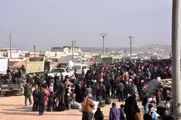 Syrians that evacuated the eastern districts of Aleppo gather to board buses, in a government held area in Aleppo, Syria in this handout picture provided by SANA on November 29, 2016. Syrians that evacuated the eastern districts of Aleppo gather to board buses, in a government held area in Aleppo, Syria in this handout picture provided by SANA on November 29, 2016. - Sputnik International