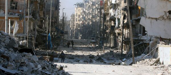 Syrians walk over rubble of damaged buildings, while carrying their belongings, as they flee clashes between government forces and rebels in Tariq al-Bab and al-Sakhour neighborhoods of eastern Aleppo towards other rebel held besieged areas of Aleppo, Syria. - Sputnik International