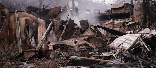 Smokes still rises out of the remains of a burned-out business in Gatlinburg, Tenn., after a wildfire swept through the area Smokes still rises out of the remains of a burned-out business in Gatlinburg, Tenn., after a wildfire swept through the area - Sputnik International