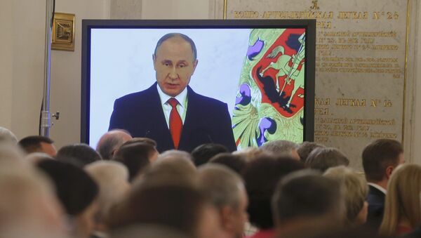 Russian President Vladimir Putin is seen on a screen during his annual state of the nation address at the Kremlin in Moscow, Russia, December 1, 2016 - Sputnik International