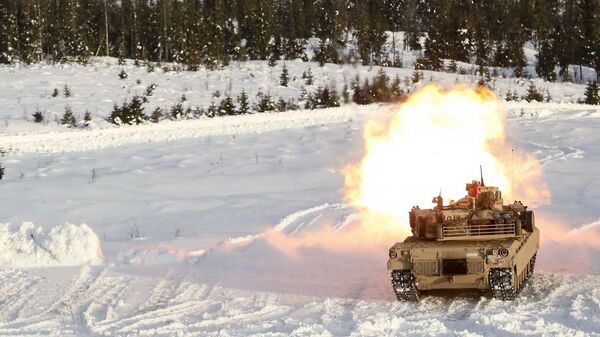 A M1A1 Abrams Tank fires its main gun as it takes part in a live-fire exercise in Rena, Norway, Feb. 18, 2016 - Sputnik International