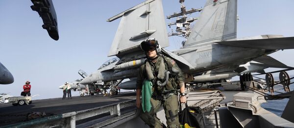 In this Tuesday, Nov. 22, 2016 photo, Lt. Jennifer Sandifer, a 27-year old fighter pilot from Austin, Texas, walks towards F/A-18E Super Hornet jet before launching from the deck of the U.S.S. Dwight D. Eisenhower aircraft carrier towards targets in Iraq and Syria In this Tuesday, Nov. 22, 2016 photo, Lt. Jennifer Sandifer, a 27-year old fighter pilot from Austin, Texas, walks towards F/A-18E Super Hornet jet before launching from the deck of the U.S.S. Dwight D. Eisenhower aircraft carrier towards targets in Iraq and Syria - Sputnik International