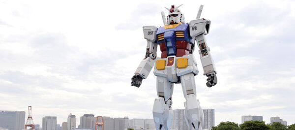 Japanese people admire an 18-metre tall statue of popular TV animation hero, Gundam, at a Tokyo park (File) Japanese people admire an 18-metre tall statue of popular TV animation hero, Gundam, at a Tokyo park (File) - Sputnik International
