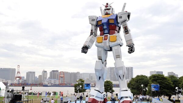 Japanese people admire an 18-metre tall statue of popular TV animation hero, Gundam, at a Tokyo park (File) - Sputnik International