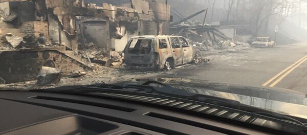Burned buildings and cars aftermath of wildfire is seen in this image released in social media by Tennessee Highway Patrol in Gatlinburg, Tennessee, U.S. on November 29, 2016 Burned buildings and cars aftermath of wildfire is seen in this image released in social media by Tennessee Highway Patrol in Gatlinburg, Tennessee, U.S. on November 29, 2016 - Sputnik International