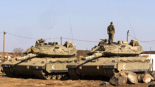 An Israeli soldier stands on top of a Merkava tank near the border with Syria in the Israeli-annexed Golan Heights, on November 28, 2016 - Sputnik International