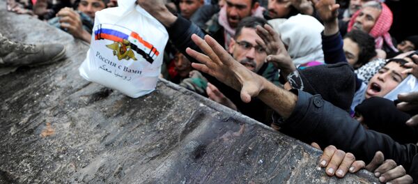 Syrians who have been evacuated from eastern Aleppo, reach out for Russian food aid in government-controlled Jibreen area in Aleppo, Syria November 30, 2016 Syrians who have been evacuated from eastern Aleppo, reach out for Russian food aid in government-controlled Jibreen area in Aleppo, Syria November 30, 2016 - Sputnik International