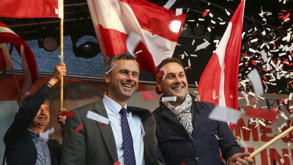In this May 20, 2016 file photo Norbert Hofer candidate for presidential elections of Austria's Freedom Party, FPOE, and Heinz-Christian Strache, from left, head of Austria's Freedom Party, FPOE, look out at supporters during the final election campaign event in Vienna - Sputnik International