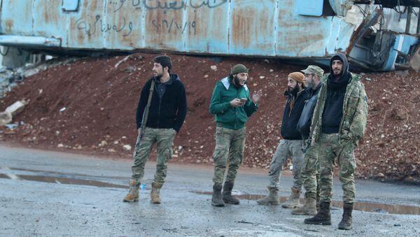 Rebel fighters stand near a damaged bus used as a barricade in the rebel-held besieged Bab al-Hadid neighbourhood of Aleppo, Syria December 2, 2016 - Sputnik International