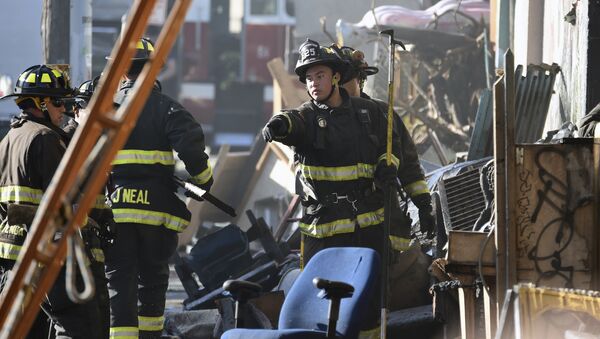 Firefighters assess the scene where a deadly fire tore through a late-night electronic music party in a warehouse in Oakland, Calif., Saturday, Dec. 3, 2016. Officials described the scene inside the warehouse, which had been illegally converted into artist studios, as a death trap that made it impossible for many partygoers to escape the Friday night fire. - Sputnik International