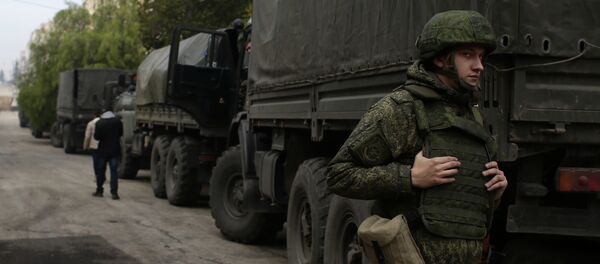 A Russian soldier stands next to an aid convoy in Aleppo, Syria, Sunday, Dec. 4, 2016 A Russian soldier stands next to an aid convoy in Aleppo, Syria, Sunday, Dec. 4, 2016 - Sputnik International