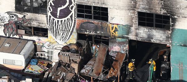 Firefighters work inside the burned warehouse following the fatal fire in the Fruitvale district of Oakland, California, U.S. December 4, 2016 - Sputnik International