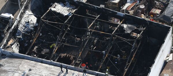 Firefighters work inside the burned warehouse following the fatal fire in the Fruitvale district of Oakland, California, U.S. December 4, 2016 - Sputnik International