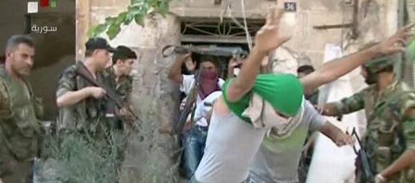 This still image from Syrian state TV video, shows young men with their faces covered surrendering to government forces, in Aleppo, Syria, Saturday, July 30, 2016 This still image from Syrian state TV video, shows young men with their faces covered surrendering to government forces, in Aleppo, Syria, Saturday, July 30, 2016 - Sputnik International