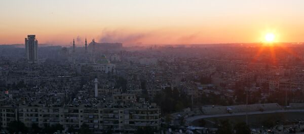 The sun rises while smoke is pictured near Aleppo's historic citadel, as seen from a government-controlled area of Aleppo, Syria December 6, 2016. The sun rises while smoke is pictured near Aleppo's historic citadel, as seen from a government-controlled area of Aleppo, Syria December 6, 2016. - Sputnik International