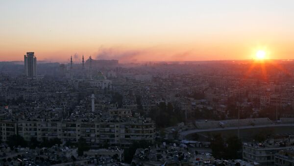 The sun rises while smoke is pictured near Aleppo's historic citadel, as seen from a government-controlled area of Aleppo, Syria December 6, 2016. - Sputnik International