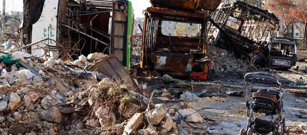 An abandoned child stroller is seen near damaged vehicles which were used as barricades in Hanano housing district after government forces took control of the area in Aleppo, Syria December 2, 2016. - Sputnik International