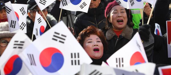 Supporters of South Korean President Park Geun-Hye wave the national flags during a rally against the impeachment of the president outside the ruling Saenuri Party in Seoul on December 6, 2016. Supporters of South Korean President Park Geun-Hye wave the national flags during a rally against the impeachment of the president outside the ruling Saenuri Party in Seoul on December 6, 2016. - Sputnik International