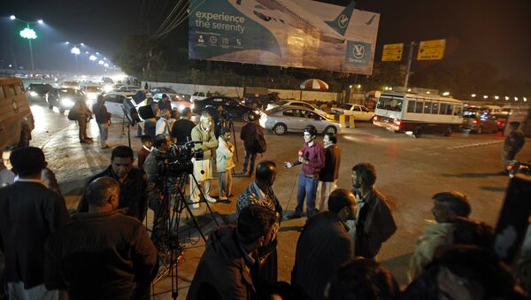 Pakistani media and residents gather at Benazir Bhutto International Airport following a report that a passenger plane from Chitral, in the country's north, had crashed near a village near the town of Havelian, in Islamabad, Pakistan, Wednesday, Dec. 7, 2016. - Sputnik International