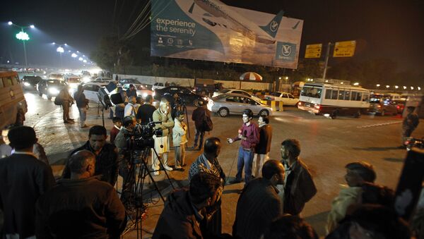 Pakistani media and residents gather at Benazir Bhutto International Airport following a report that a passenger plane from Chitral, in the country's north, had crashed near a village near the town of Havelian, in Islamabad, Pakistan - Sputnik International