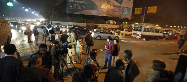 Pakistani media and residents gather at Benazir Bhutto International Airport following a report that a passenger plane from Chitral, in the country's north, had crashed near a village near the town of Havelian, in Islamabad, Pakistan - Sputnik International