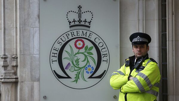 A police officer stands guard outside the Supreme Court on the last day of the challenge against a court ruling that Theresa May's government requires parliamentary approval to start the process of leaving the European Union, in Parliament Square, central London, Britain December 8, 2016. - Sputnik International