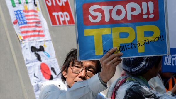 A demonstrator displays a placard to protest against the Trans Pacific Partnership (TPP) trade deal at a sit-in demonstration in front of the parliament building in Tokyo - Sputnik International