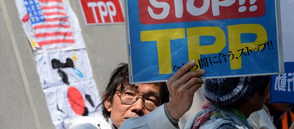 A demonstrator displays a placard to protest against the Trans Pacific Partnership (TPP) trade deal at a sit-in demonstration in front of the parliament building in Tokyo A demonstrator displays a placard to protest against the Trans Pacific Partnership (TPP) trade deal at a sit-in demonstration in front of the parliament building in Tokyo - Sputnik International