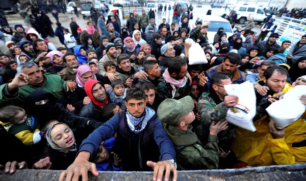 Syrians evacuated from eastern Aleppo, reach out for Russian food aid in government controlled Jibreen area in Aleppo, Syria November 30, 2016. Syrians evacuated from eastern Aleppo, reach out for Russian food aid in government controlled Jibreen area in Aleppo, Syria November 30, 2016. - Sputnik International