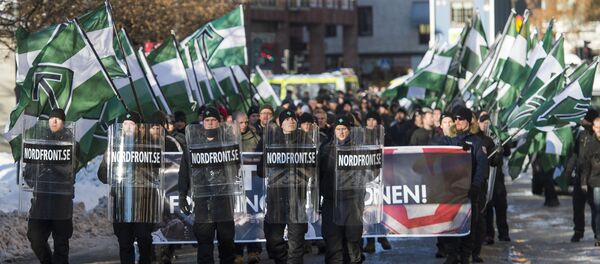 The neo-nazi Nordic Resistance Movement (Nordiska motstandsrorelsens) sympathisers demonstrate in central Stockholm on November 12, 2016 to protest against migrants. The neo-nazi Nordic Resistance Movement (Nordiska motstandsrorelsens) sympathisers demonstrate in central Stockholm on November 12, 2016 to protest against migrants. - Sputnik International