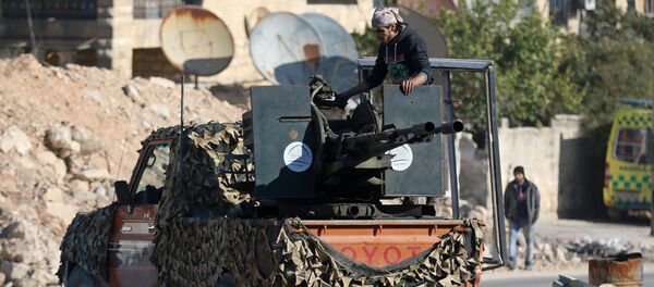 A rebel fighter stands on a pick-up truck mounted with a weapon in a rebel-held area of Aleppo, Syria December 9, 2016 - Sputnik International