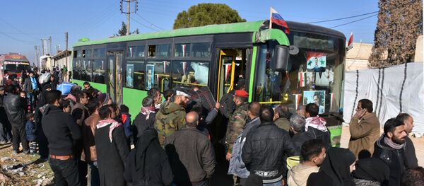 Syrian residents fleeing the violence, queue as they board a bus at a checkpoint, manned by pro-government forces, in the village of Aziza on the southwestern outskirts of the northern Syrian city of Aleppo on December 9, 2016 Syrian residents fleeing the violence, queue as they board a bus at a checkpoint, manned by pro-government forces, in the village of Aziza on the southwestern outskirts of the northern Syrian city of Aleppo on December 9, 2016 - Sputnik International