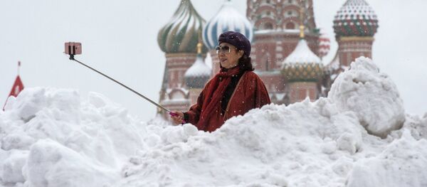 A woman is photographed near the St Basil Cathedral on the Red Square - Sputnik International
