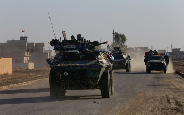 Iraqi security forces members drive a military vehicle in Qaraqosh, near Mosul, Iraq December 9, 2016 - Sputnik International