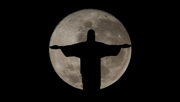 The full moon is pictured behind the Christ the Redeemer statue ahead of the 2016 Rio Olympic games in Rio de Janeiro, Brazil, July 19, 2016 - Sputnik International