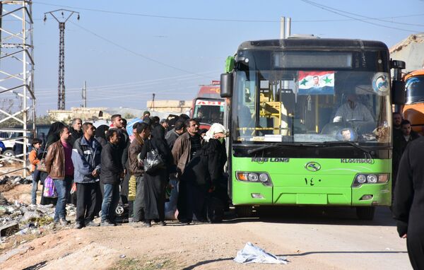 Syrian residents fleeing the violence, queue as they board a bus at a checkpoint, manned by pro-government forces, in the village of Aziza on the southwestern outskirts of the northern Syrian city of Aleppo on December 9, 2016 Syrian residents fleeing the violence, queue as they board a bus at a checkpoint, manned by pro-government forces, in the village of Aziza on the southwestern outskirts of the northern Syrian city of Aleppo on December 9, 2016 - Sputnik International