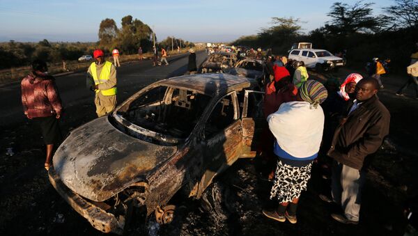 Relatives and civilians look at the wreckages of car burnt after a fireball from an tanker engulfed several vehicles and killed several people, near the Rift Valley town of Naivasha, west of Kenya's capital Nairobi, December 11, 2016 - Sputnik International