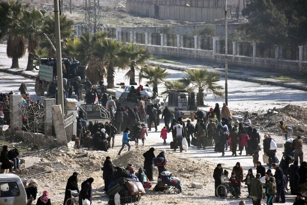 Syrian civilians arrive at a checkpoint manned by pro-government forces, at the al-Hawoz street roundabout, after leaving Aleppo's eastern neighbourhoods on December 10, 2016 Syrian civilians arrive at a checkpoint manned by pro-government forces, at the al-Hawoz street roundabout, after leaving Aleppo's eastern neighbourhoods on December 10, 2016 - Sputnik International