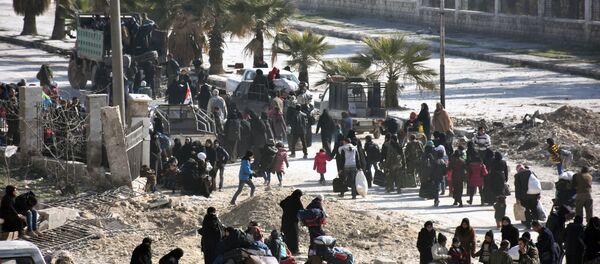 Syrian civilians arrive at a checkpoint manned by pro-government forces, at the al-Hawoz street roundabout, after leaving Aleppo's eastern neighbourhoods on December 10, 2016 Syrian civilians arrive at a checkpoint manned by pro-government forces, at the al-Hawoz street roundabout, after leaving Aleppo's eastern neighbourhoods on December 10, 2016 - Sputnik International