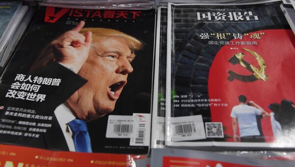 A magazine featuring US President-elect Donald Trump is seen at a bookstore in Beijing on December 12, 2016. The headline reads How will businessman Trump change the world - Sputnik International