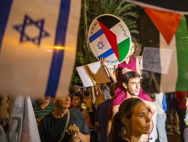 A young girl holds a bearing images of the Israeli and Palestinian flags during a Israeli left-wing activist rally demanding fresh Israeli-Palestinian peace talks, on the eve of the 20th anniversary of the killing of late Israeli prime minister Yitzhak Rabin, at the Rabin Square in the Israeli city of Tel Aviv on October 24, 2015. A young girl holds a bearing images of the Israeli and Palestinian flags during a Israeli left-wing activist rally demanding fresh Israeli-Palestinian peace talks, on the eve of the 20th anniversary of the killing of late Israeli prime minister Yitzhak Rabin, at the Rabin Square in the Israeli city of Tel Aviv on October 24, 2015. - Sputnik International