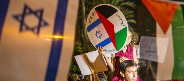 A young girl holds a bearing images of the Israeli and Palestinian flags during a Israeli left-wing activist rally demanding fresh Israeli-Palestinian peace talks, on the eve of the 20th anniversary of the killing of late Israeli prime minister Yitzhak Rabin, at the Rabin Square in the Israeli city of Tel Aviv on October 24, 2015. A young girl holds a bearing images of the Israeli and Palestinian flags during a Israeli left-wing activist rally demanding fresh Israeli-Palestinian peace talks, on the eve of the 20th anniversary of the killing of late Israeli prime minister Yitzhak Rabin, at the Rabin Square in the Israeli city of Tel Aviv on October 24, 2015. - Sputnik International