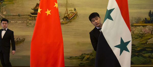 Attendants adjust Syrian and Chinese flags before a briefing at China's Ministry of Foreign Affairs in Beijing, Thursday, Dec. 24, 2015 Attendants adjust Syrian and Chinese flags before a briefing at China's Ministry of Foreign Affairs in Beijing, Thursday, Dec. 24, 2015 - Sputnik International