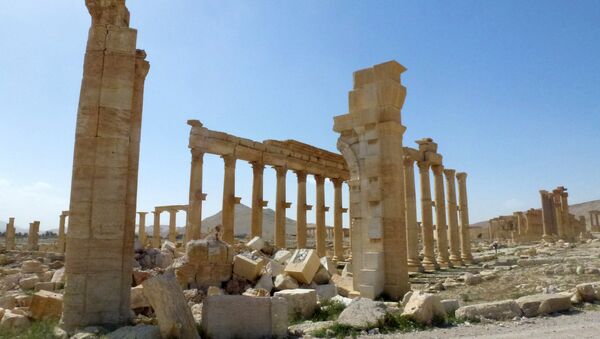 This file photo taken on March 27, 2016 shows a view of the remains of Arch of Triumph, also called the Monumental Arch of Palmyra, that was destroyed by Islamic State (IS) group jihadists in October 2015 in the ancient Syrian city of Palmyra - Sputnik International