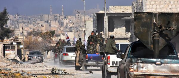 Syrian pro-government forces patrol Aleppo's Sheikh Saeed district, on December 12, 2016, after troops retook the area from rebel fighters - Sputnik International