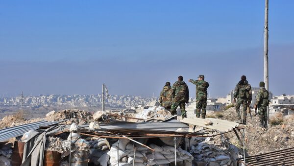 Syrian pro-government forces patrol Aleppo's Sheikh Saeed district, on December 12, 2016, after troops retook the area from rebel fighters - Sputnik International
