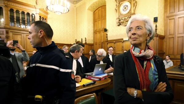 Managing Director of the International Monetary Fund (IMF) Christine Lagarde reacts before the start of her trial about a state payout in 2008 to a French businessman, at the courts in Paris, France, December 12, 2016 - Sputnik International